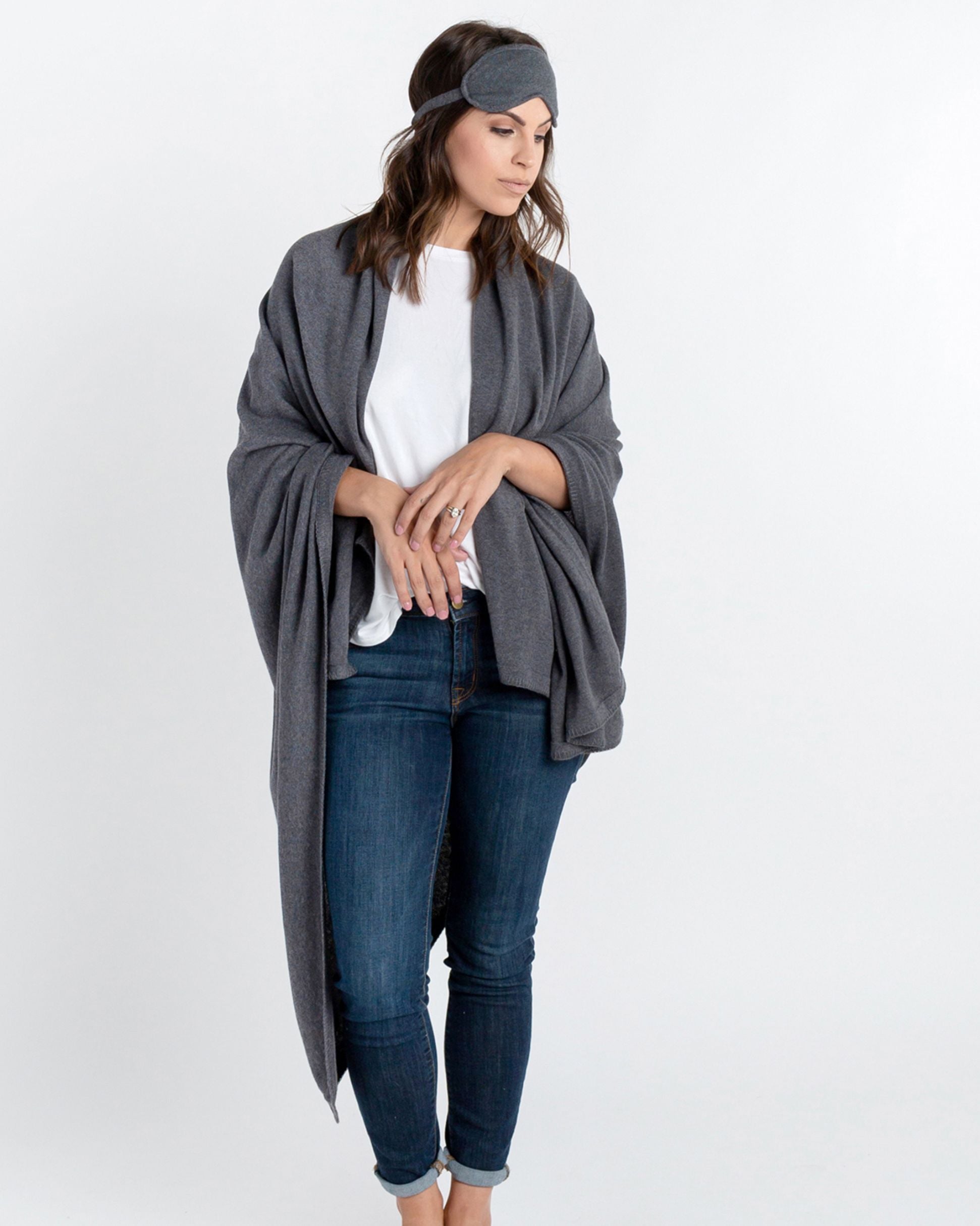 Woman shown wearing Dark Gray Travel Set blanket and eye mask