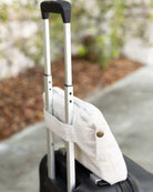 Light Gray Travel Set Carry pouch sitting on suitcase handle