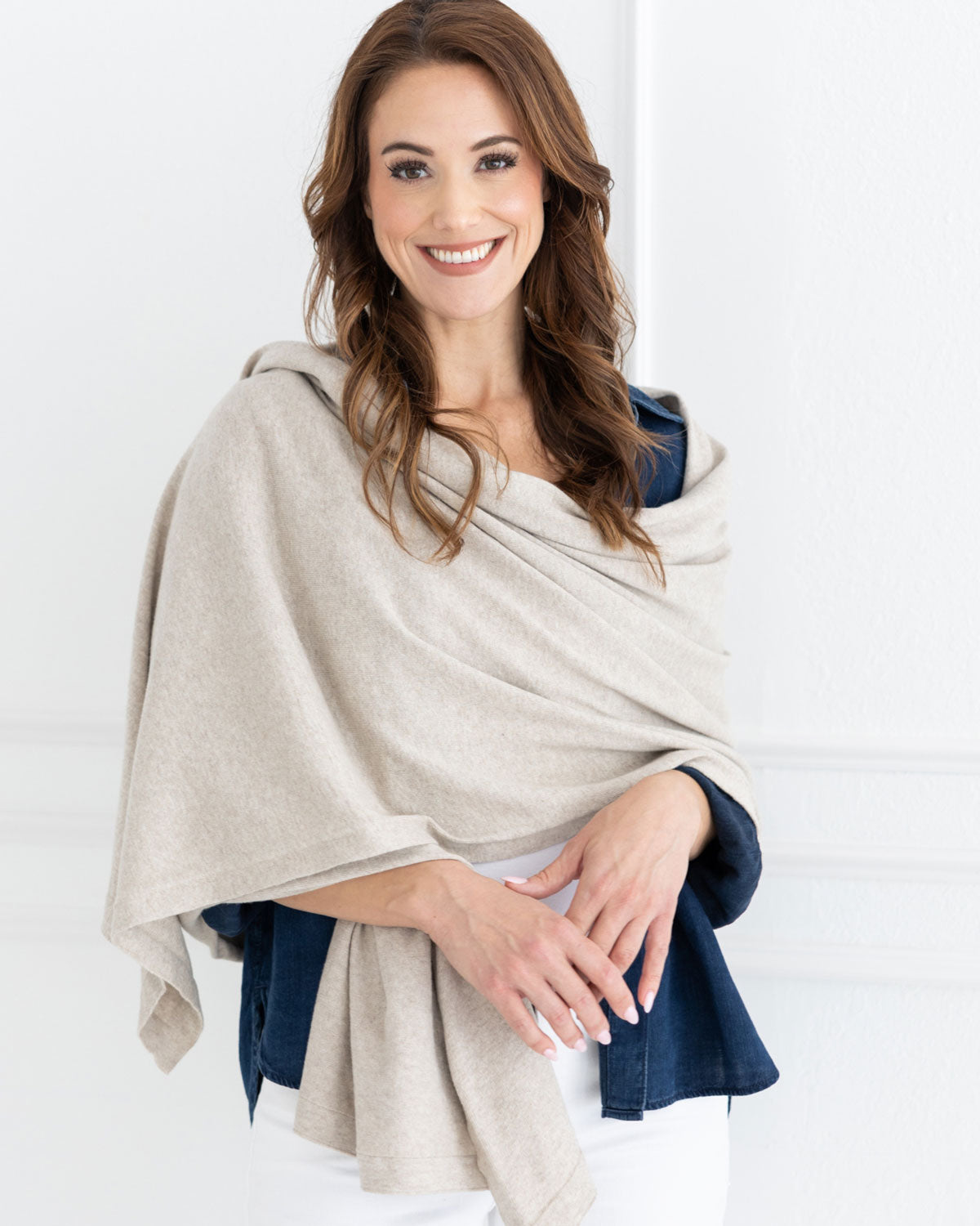 Woman wearing the Dreamsoft Travel Scarf in Birch Scarf which is a cream scarf