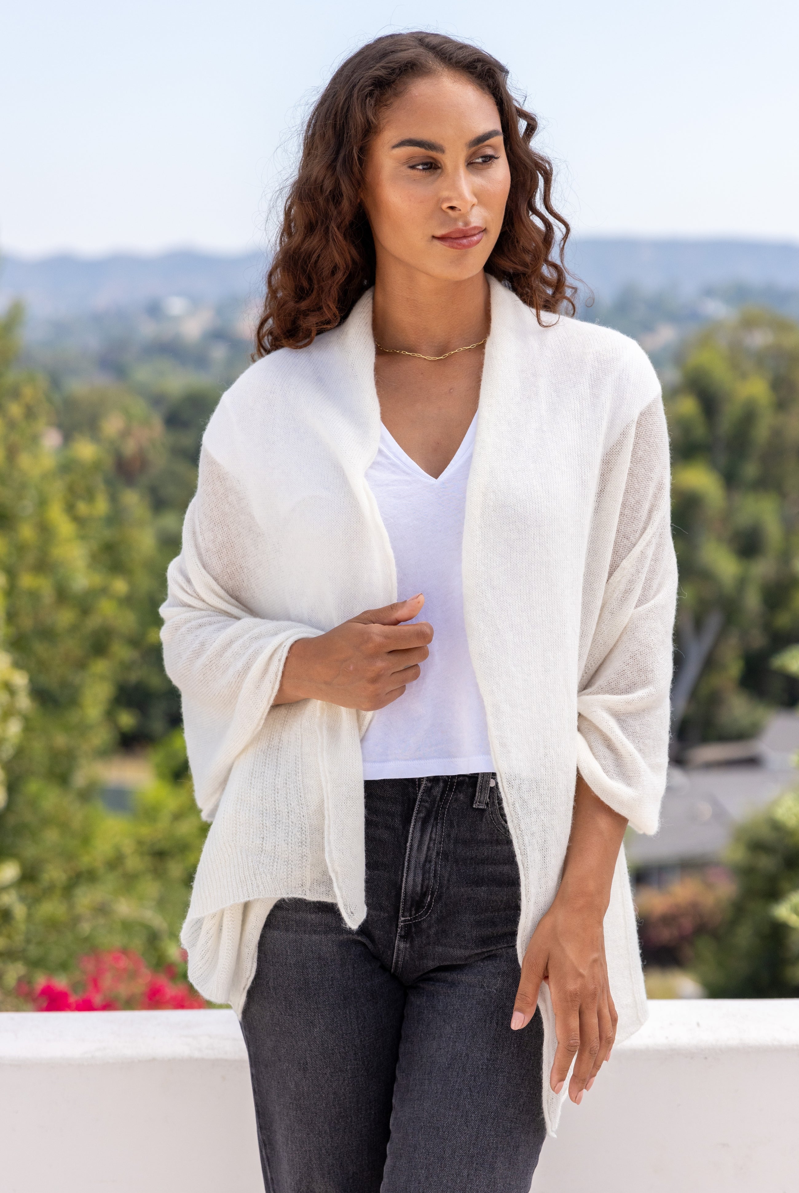 Woman shown wearing an Ivory scarf draped over her shoulders