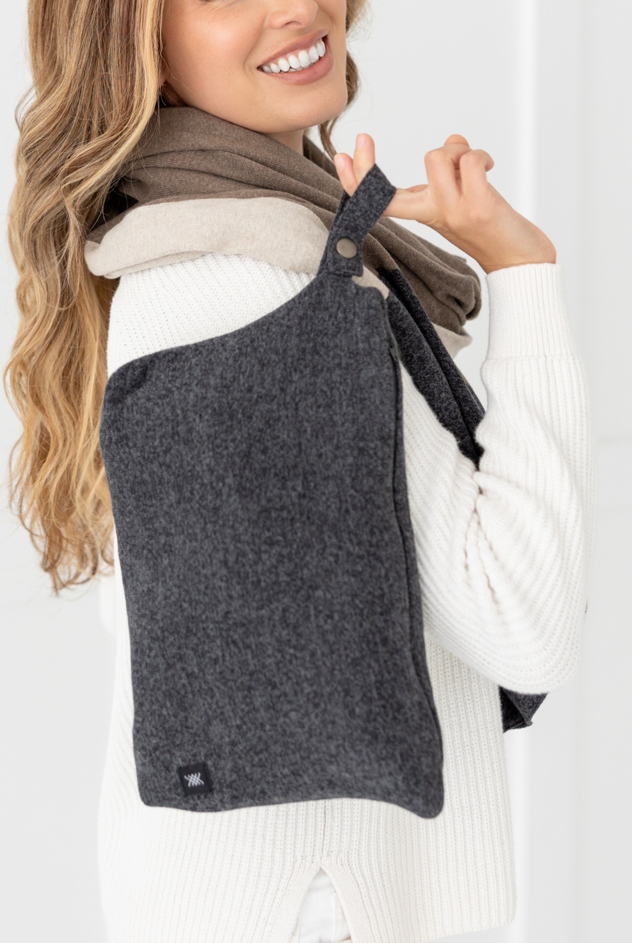 Woman shown holding gray carry pouch