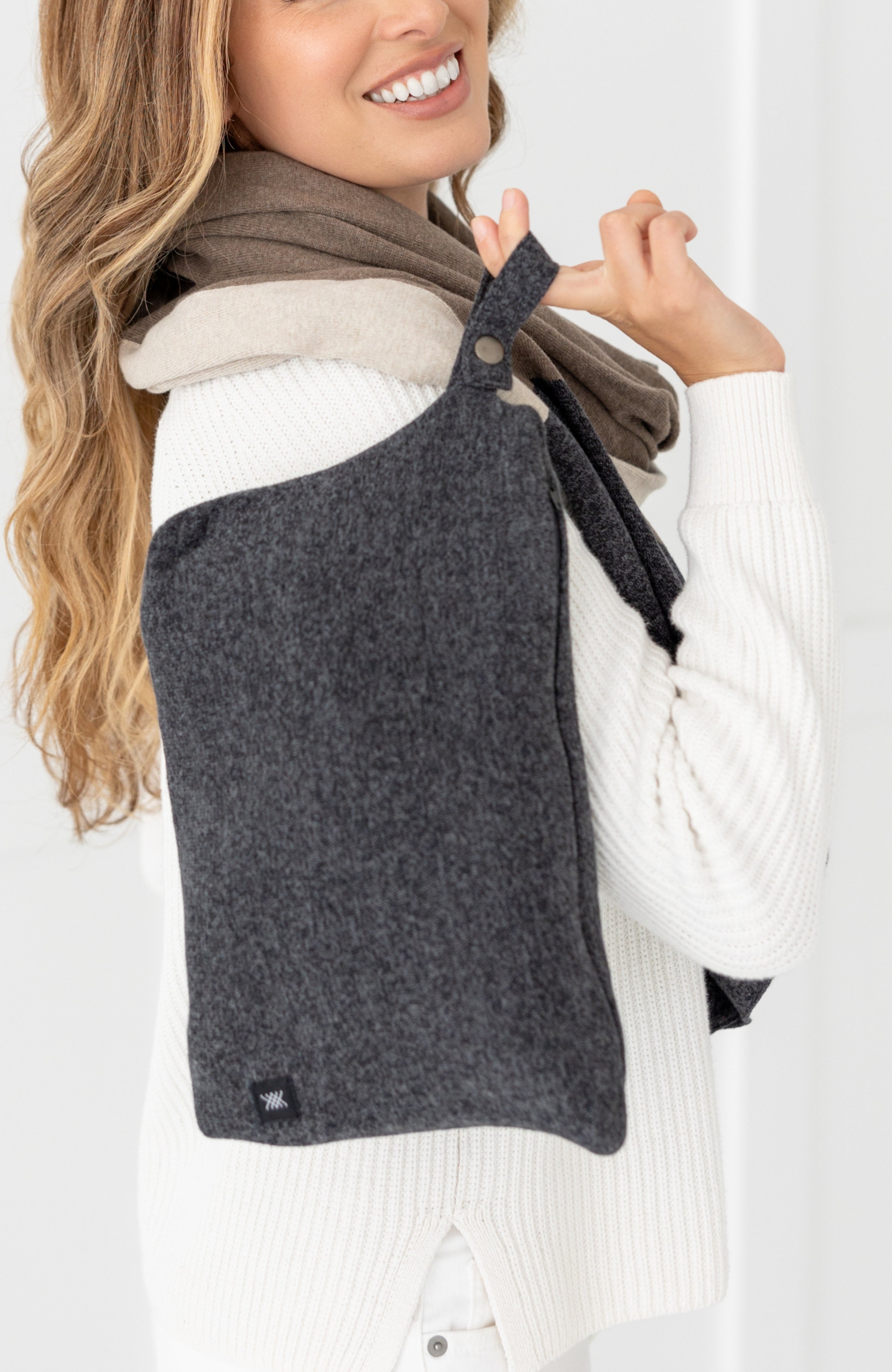 Woman shown holding gray carry pouch