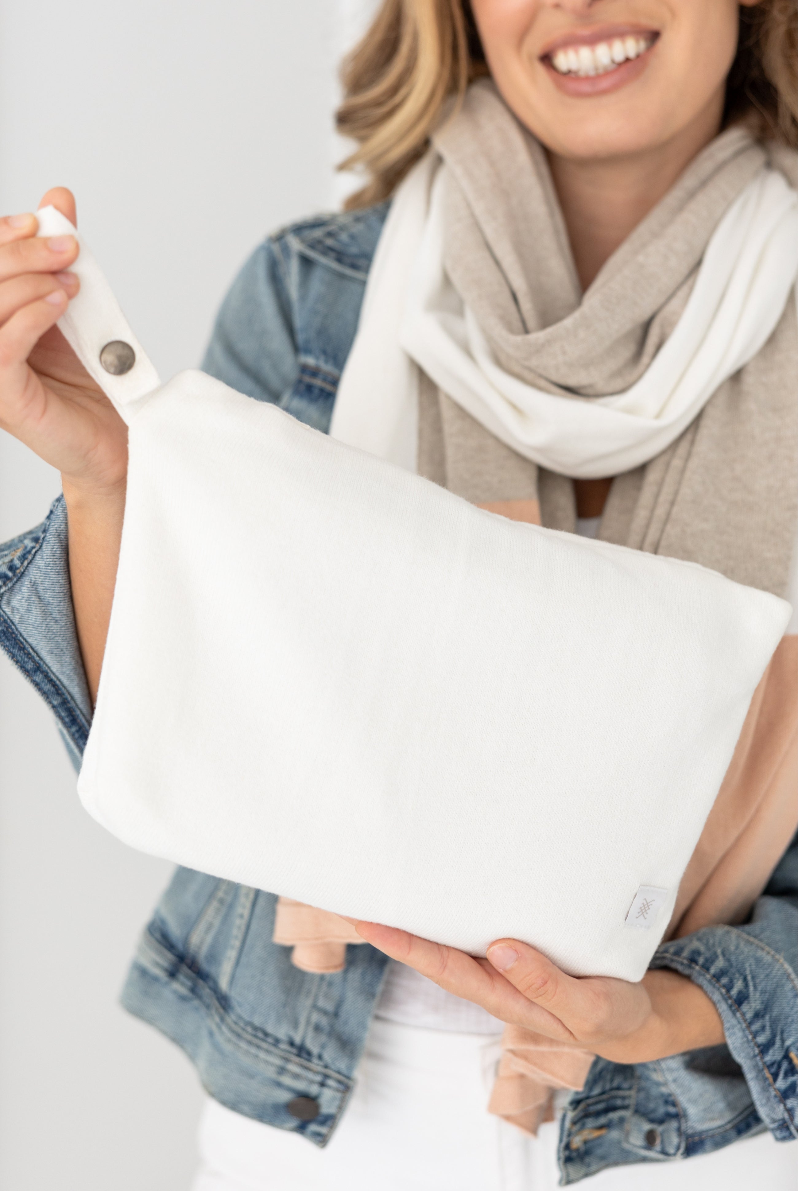 Woman shown holding Ivory carry pouch