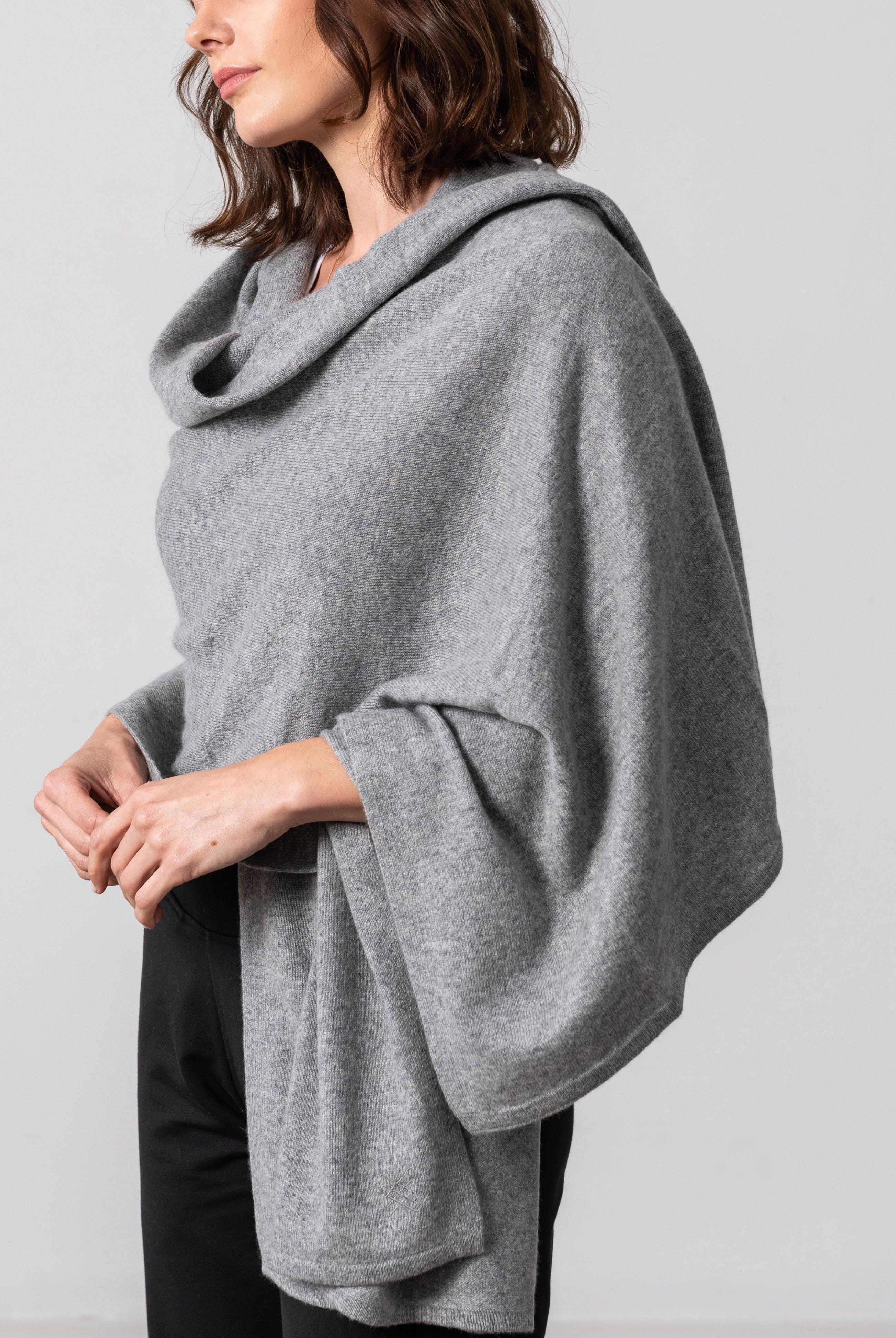 Woman shown wearing a gray scarf draped around her shoulders