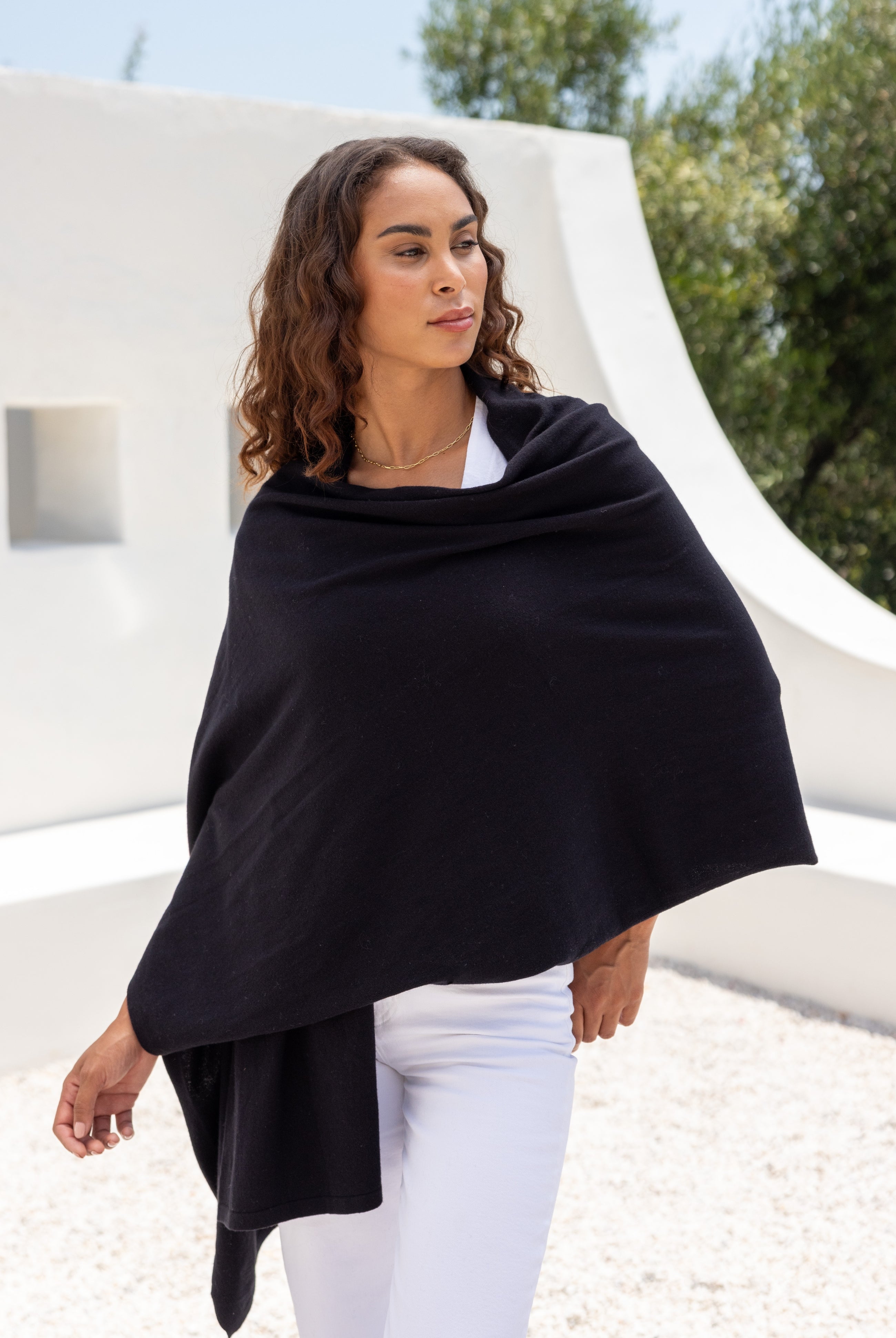 Woman shown wearing Black Scarf wrapped around shoulders