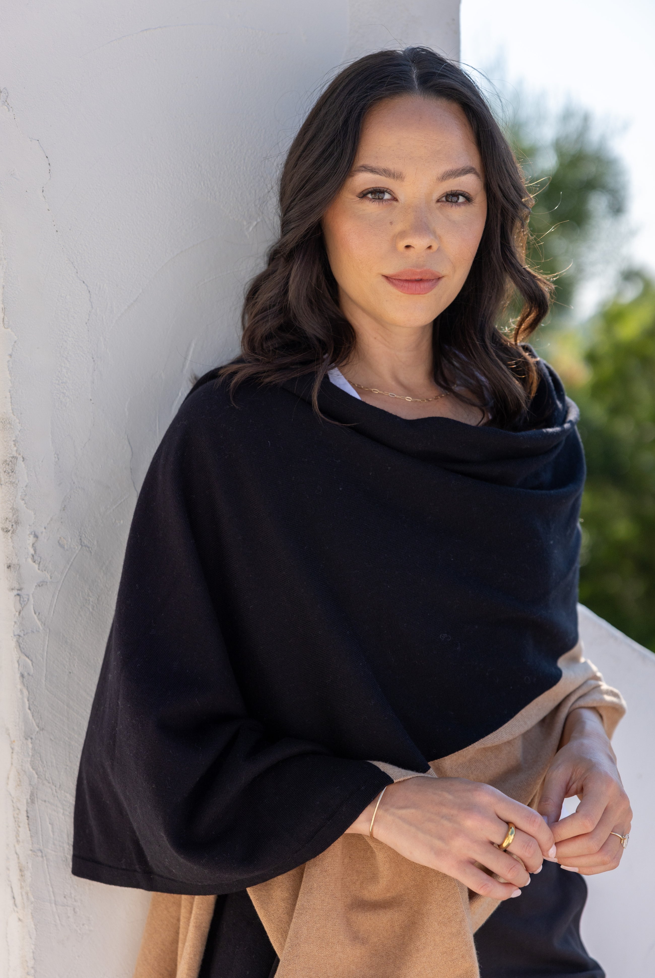 Woman shown wearing Black and Beige Scarf wrapped around shoulders
