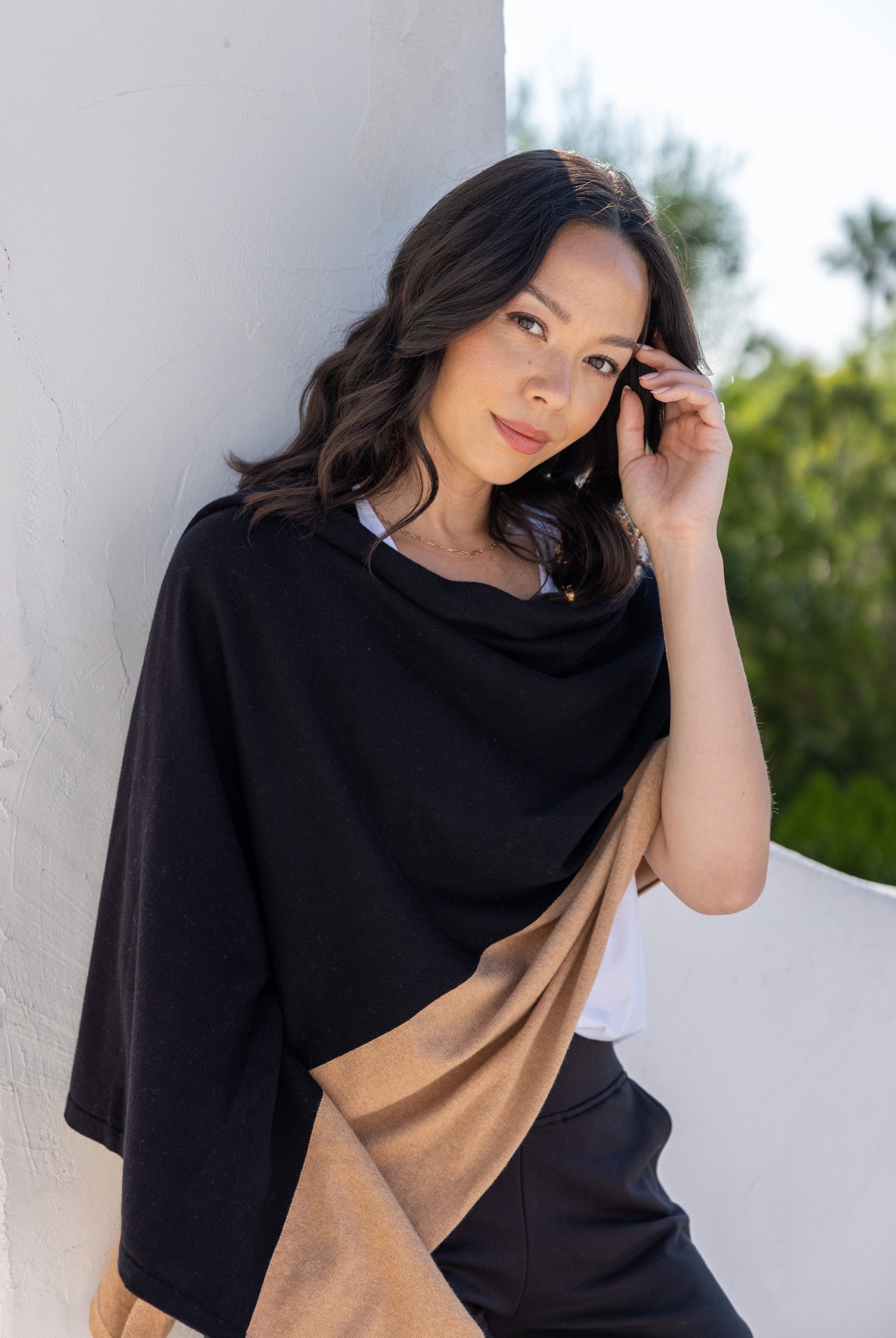 Woman shown wearing Black and Beige Scarf wrapped around shoulders