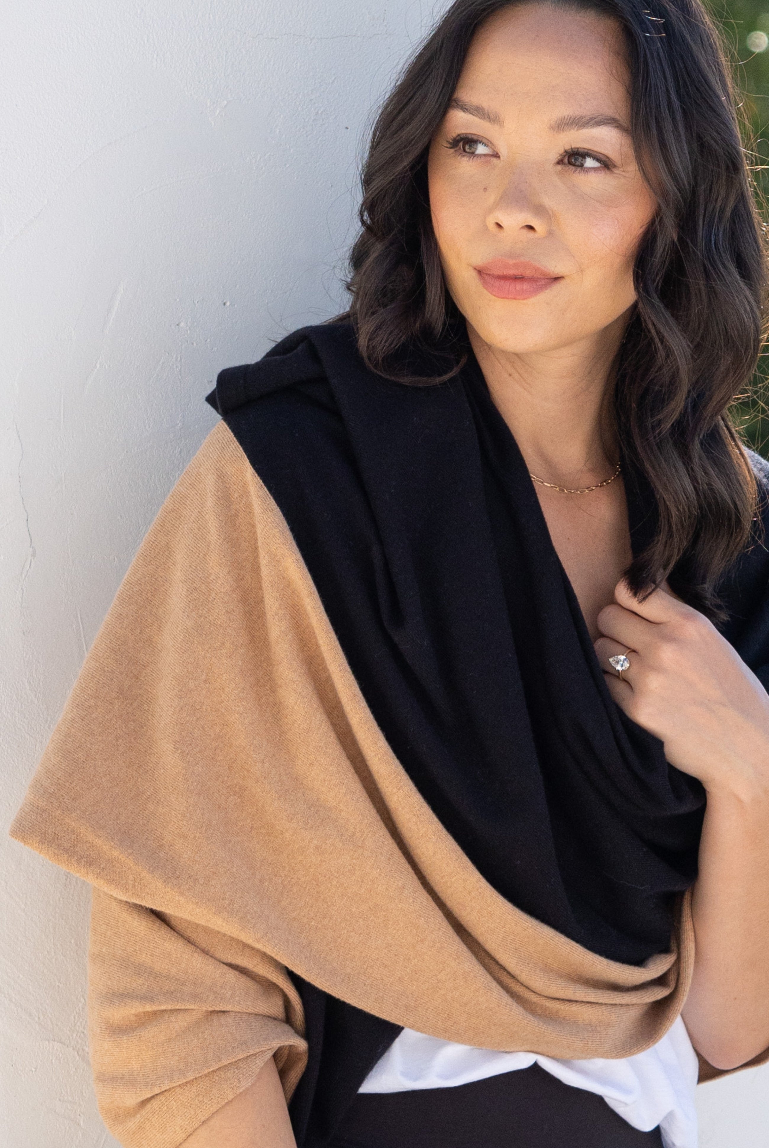 Woman shown wearing Black and Beige Scarf wrapped around shoulders