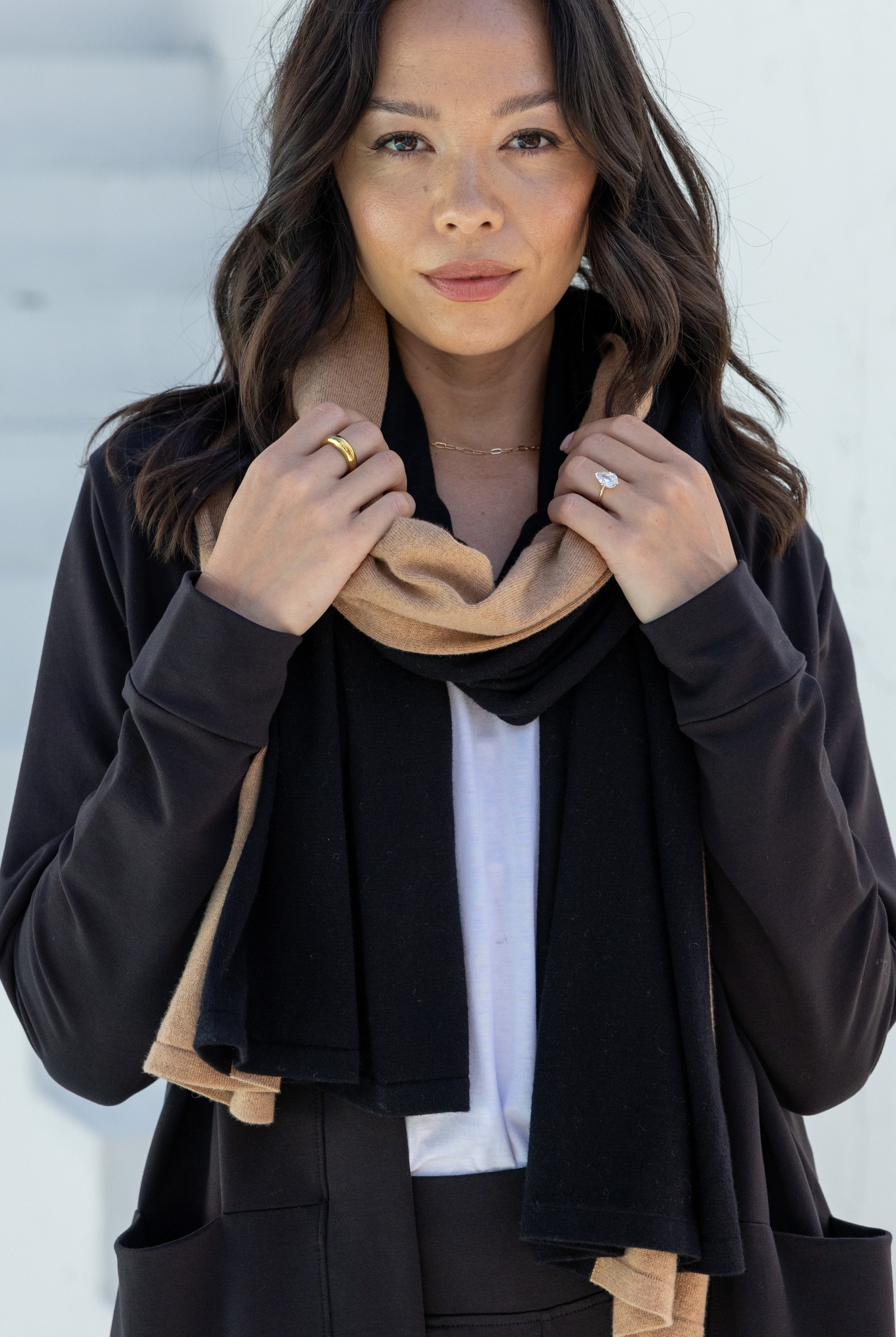 Woman shown wearing Black and Beige Scarf wrapped around her neck