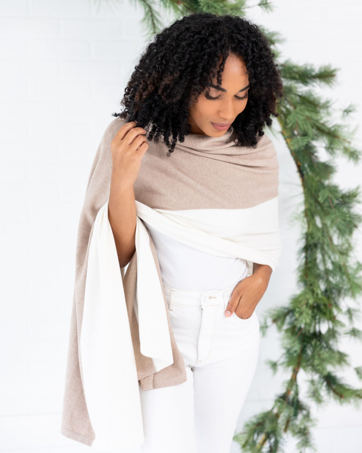 Woman wearing the Cashmere Cotton Luxe Travel Scarf in Sandstone and Ivory Colorblock which is a tan and cream scarf, worn as a wrap