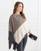 Woman wearing the Dreamsoft Travel Scarf in Brownstone Colorblock which is a brown, tan and gray scarf, worn as a wrap while holding a wallet in her hand