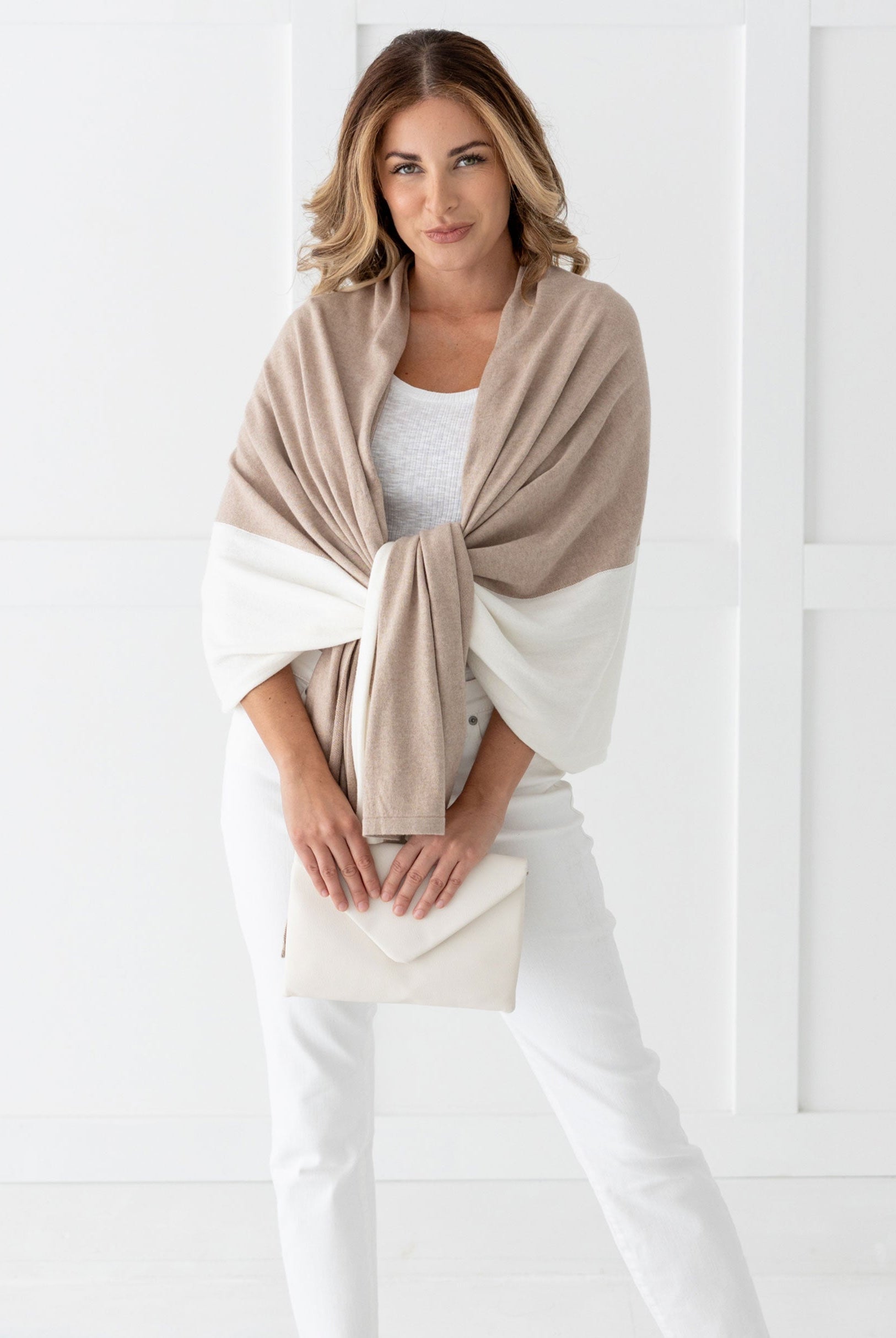 Woman wearing the Cashmere Cotton Luxe Travel Scarf in Sandstone and Ivory Colorblock which is a tan and cream scarf