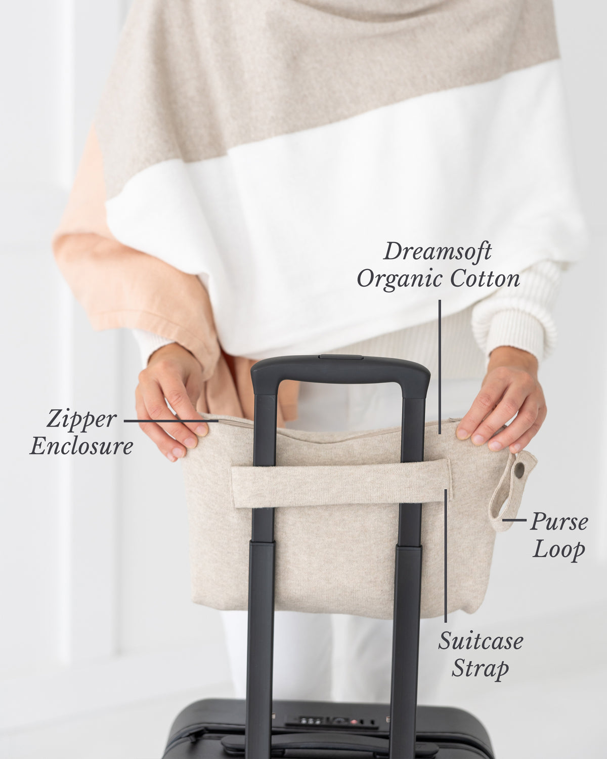Woman holding Birch Carry Pouch which is a beige zipper pouch that can hold the Dreamsoft Travel Scarf over handle on suitcase- Features shown are Zipper Enclosure, Purse Loop and Suitcase Strap