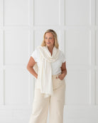 Woman wearing the Ivory Dreamsoft Travel Scarf as a scarf