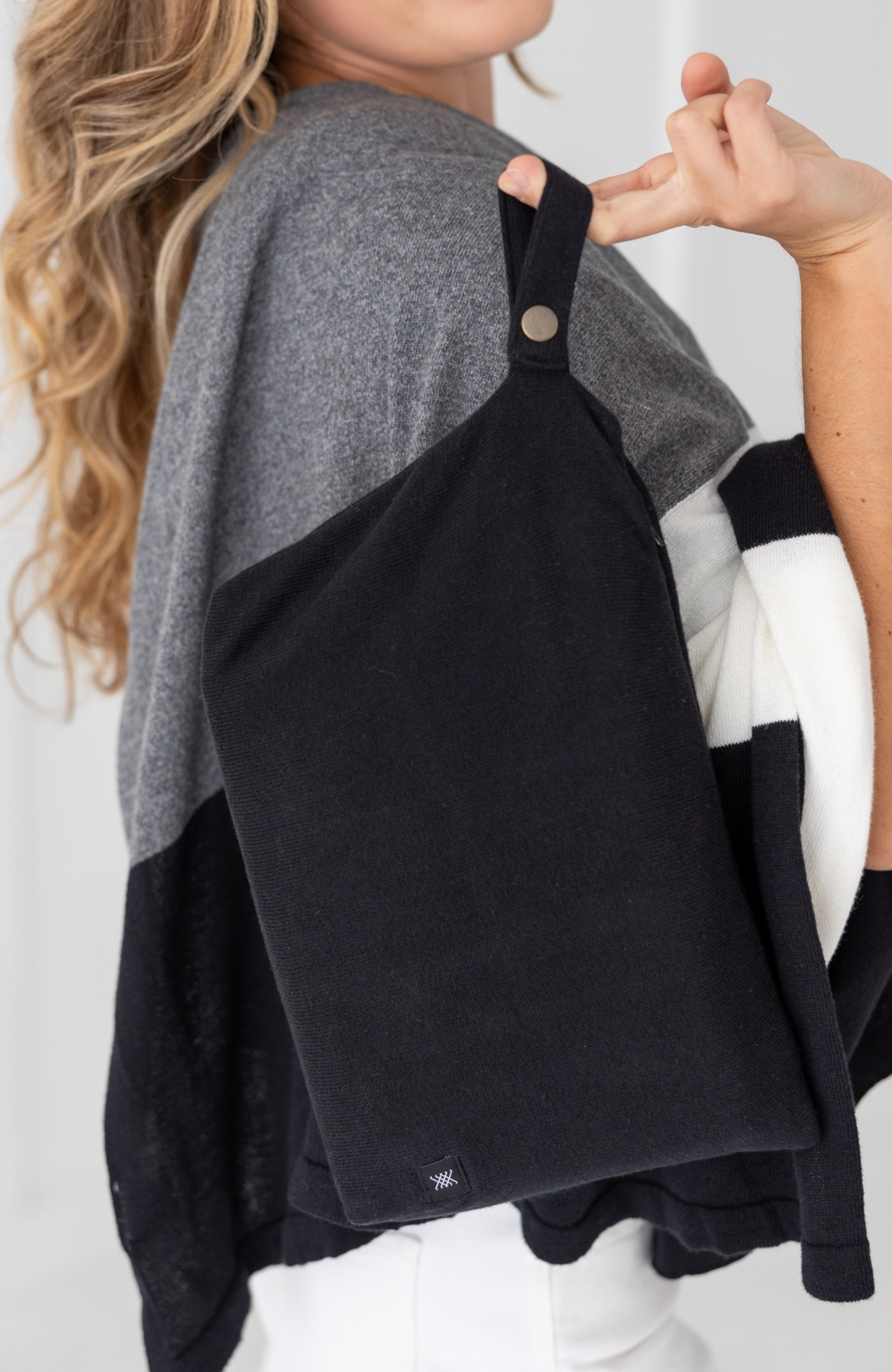 Woman shown holding black carry pouch