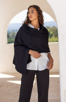 Woman wearing a Black Scarf draped around her shoulders