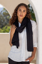 Woman wearing a Black Scarf wrapped around her neck