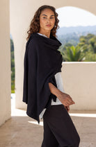 Woman wearing a Black Scarf draped around her shoulders