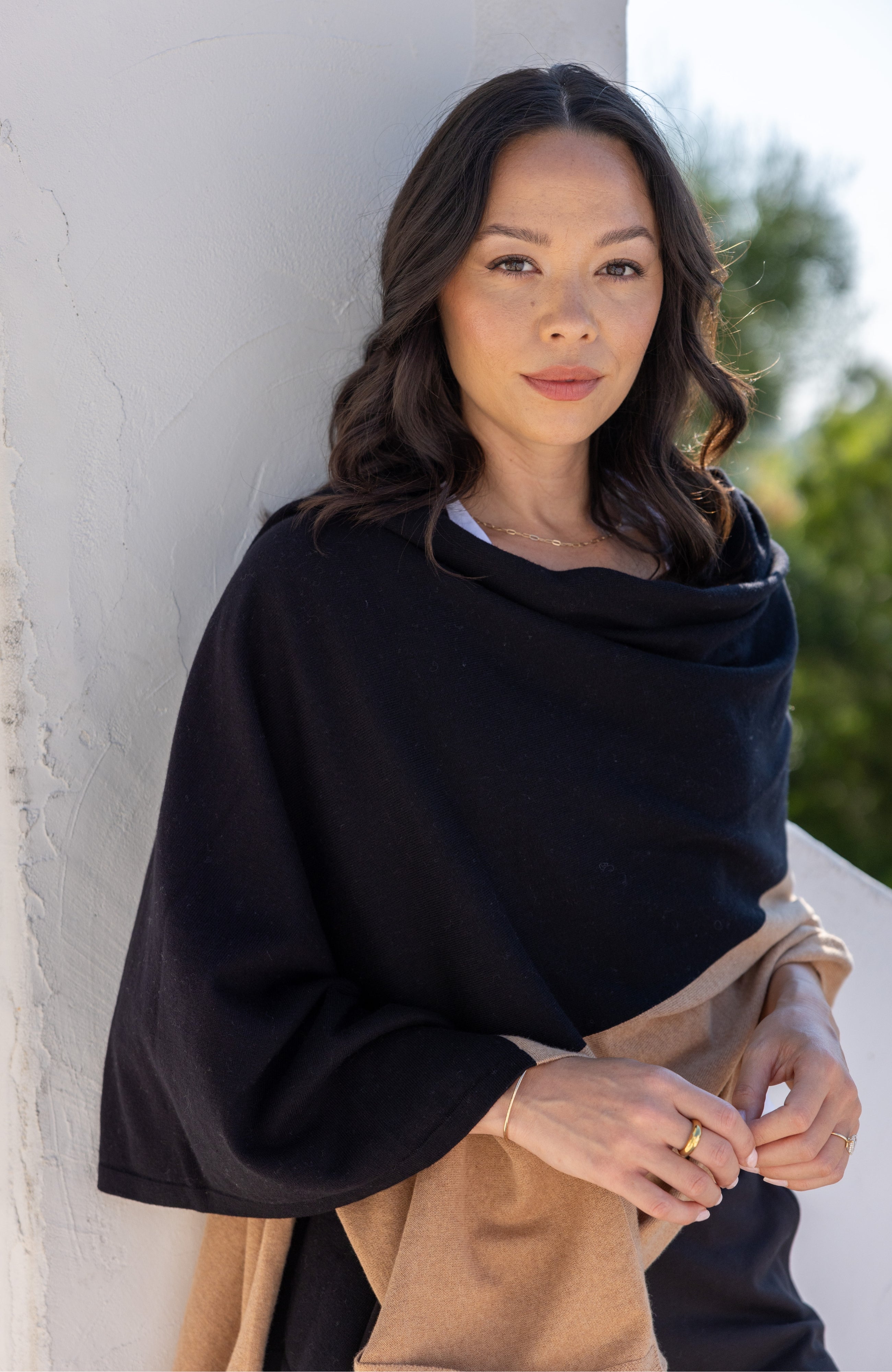 Woman shown wearing Black and Beige Scarf wrapped around shoulders