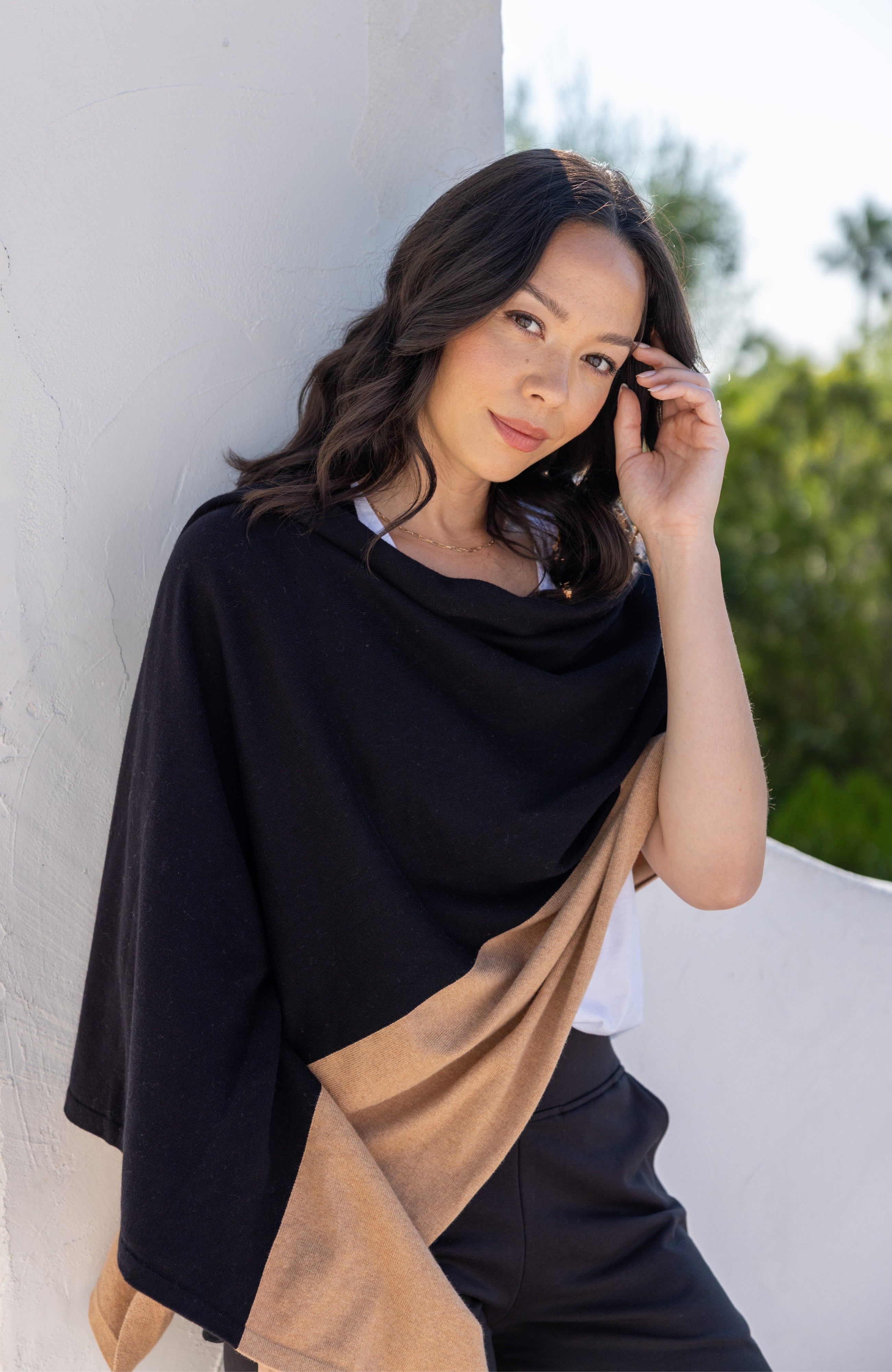 Woman shown wearing Black and Beige Scarf wrapped around shoulders