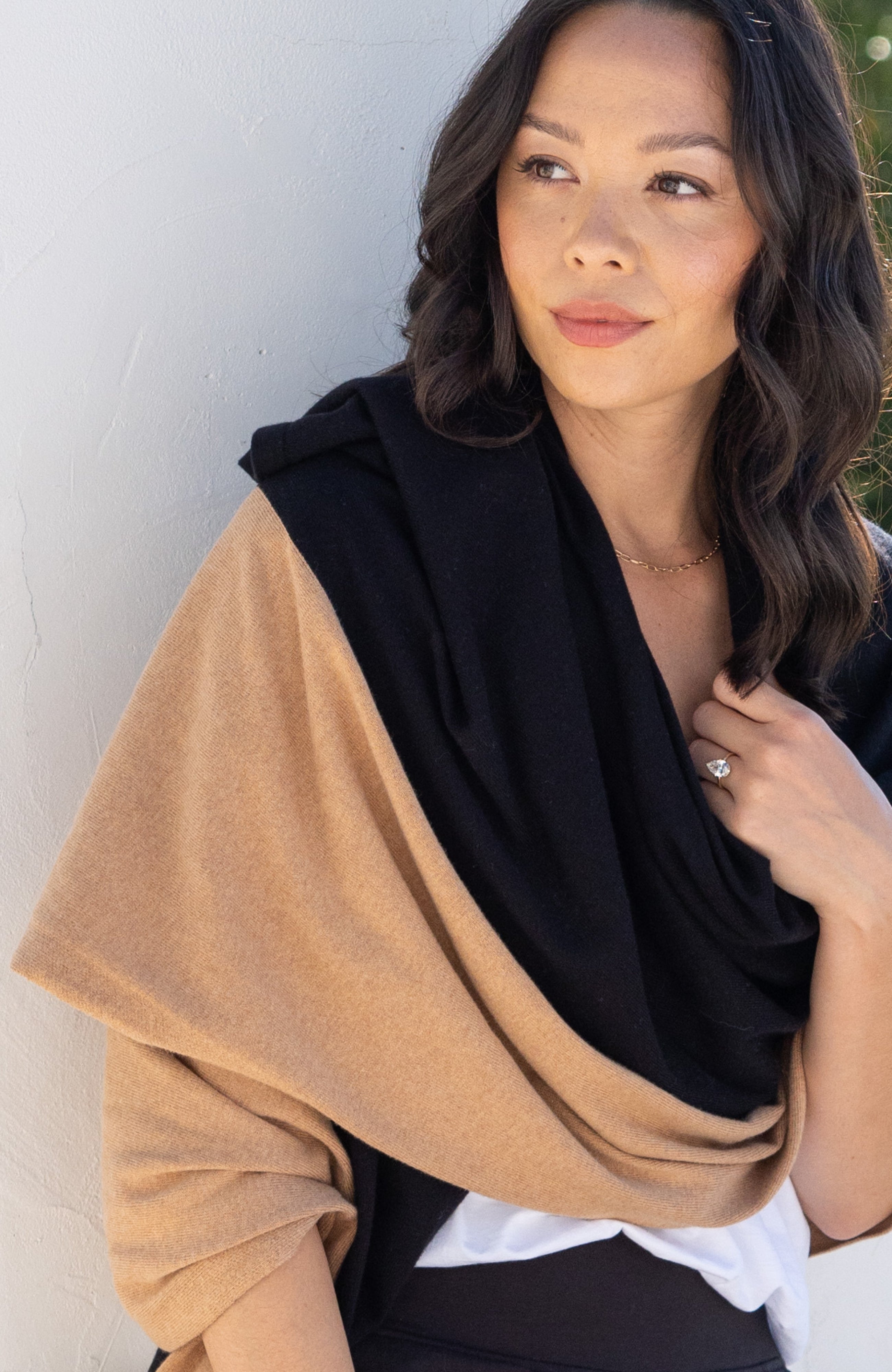 Woman shown wearing Black and Beige Scarf wrapped around shoulders