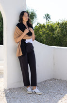 Woman shown wearing Black and Beige Scarf wrapped around shoulders