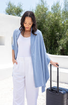 Woman shown wearing Light Blue Scarf draped over shoulders