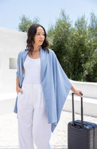 Woman shown wearing Light Blue Scarf draped over shoulders