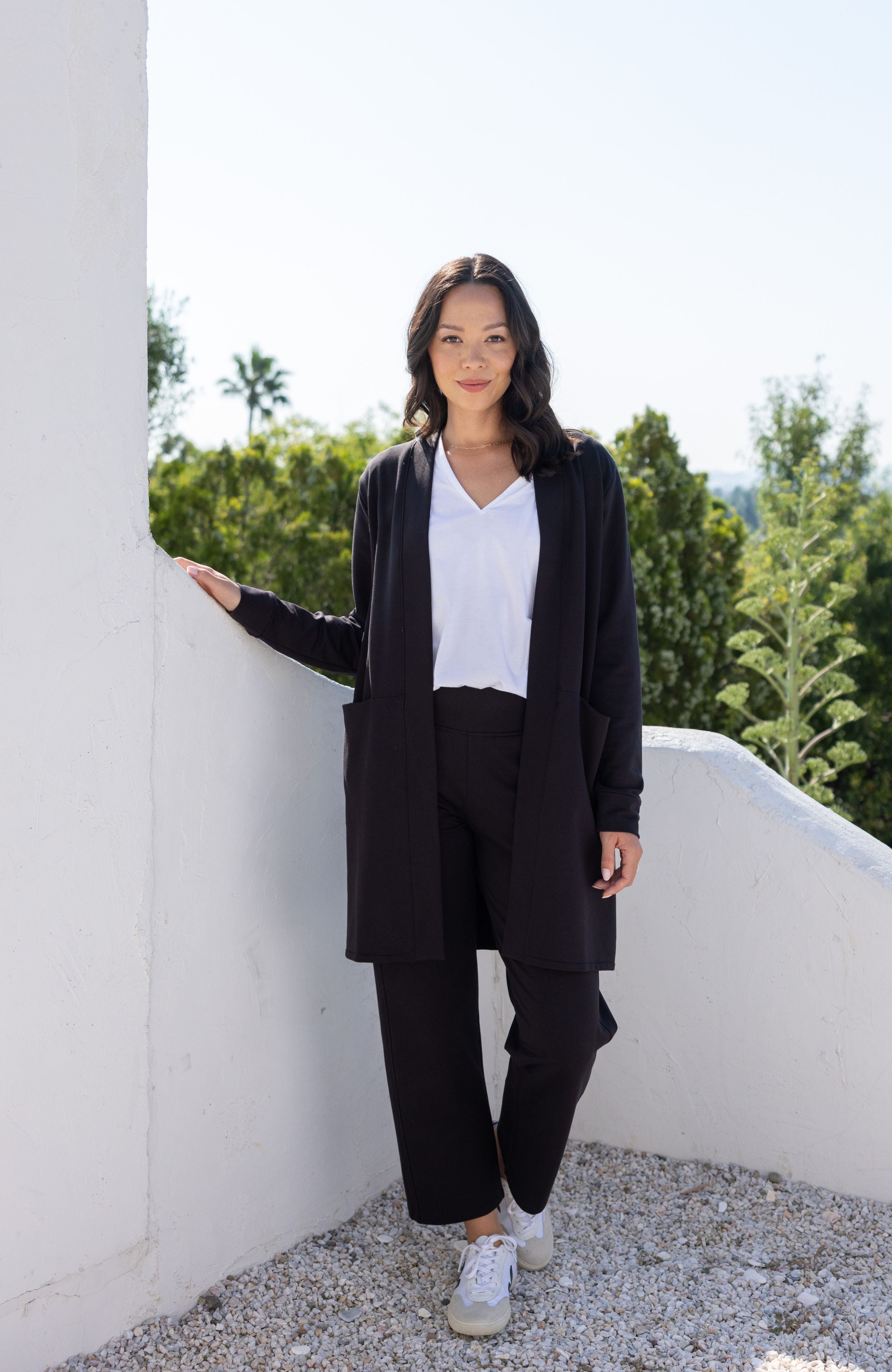 Woman shown wearing black cardigan 