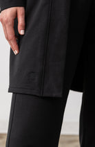 Zestt logo shown on Black cardigan