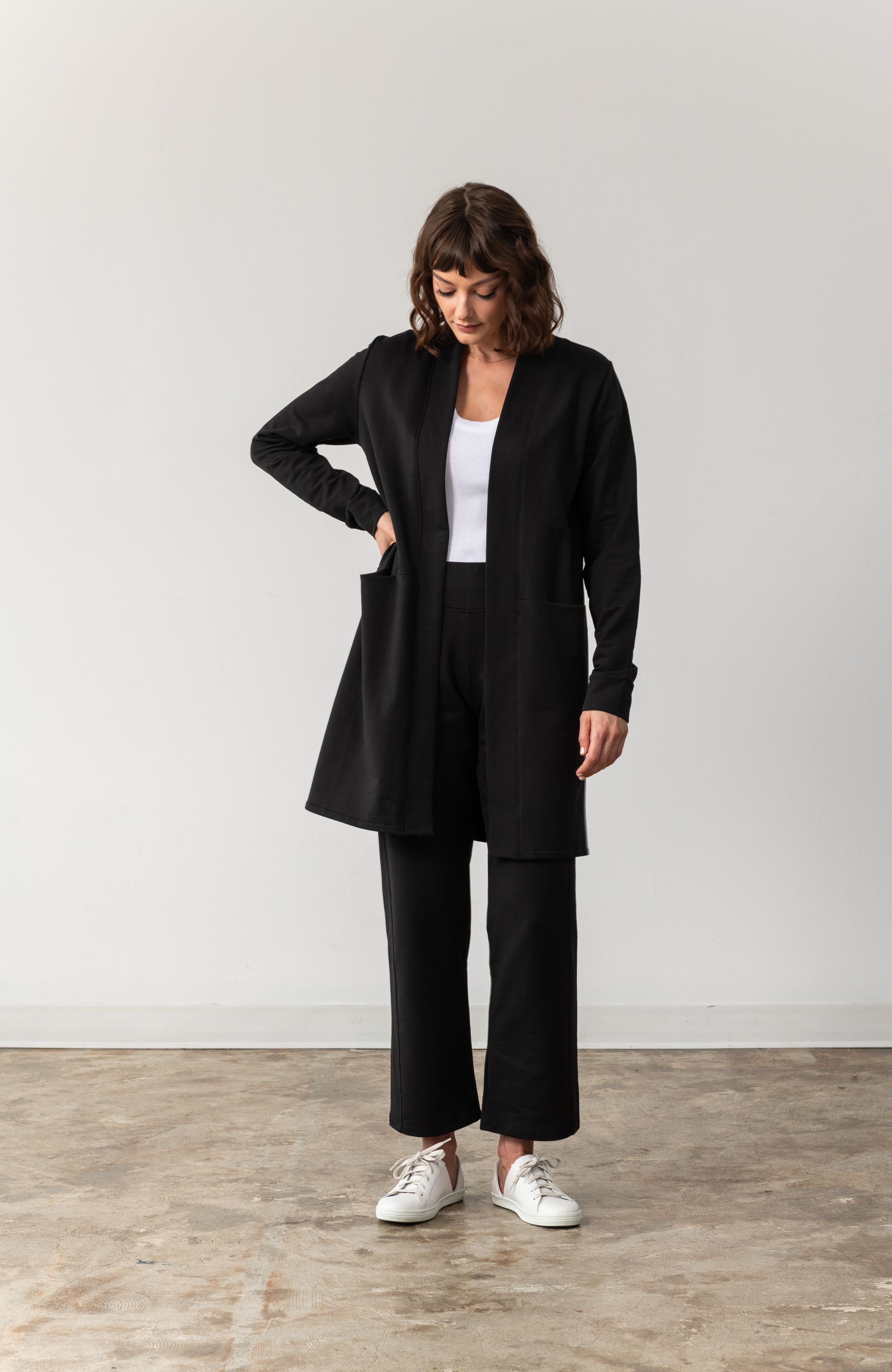 Woman shown wearing black cardigan 