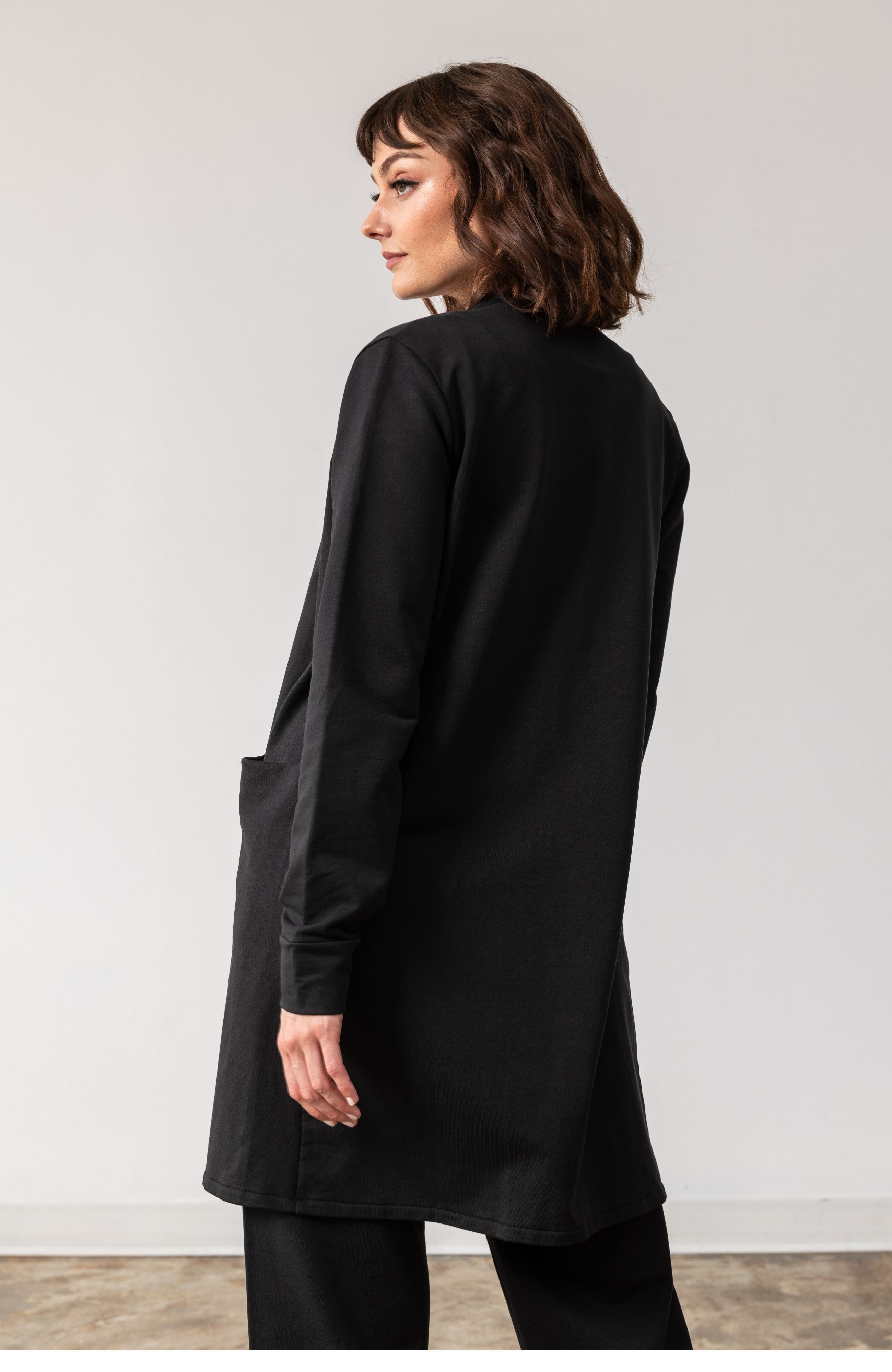 Woman shown wearing black cardigan