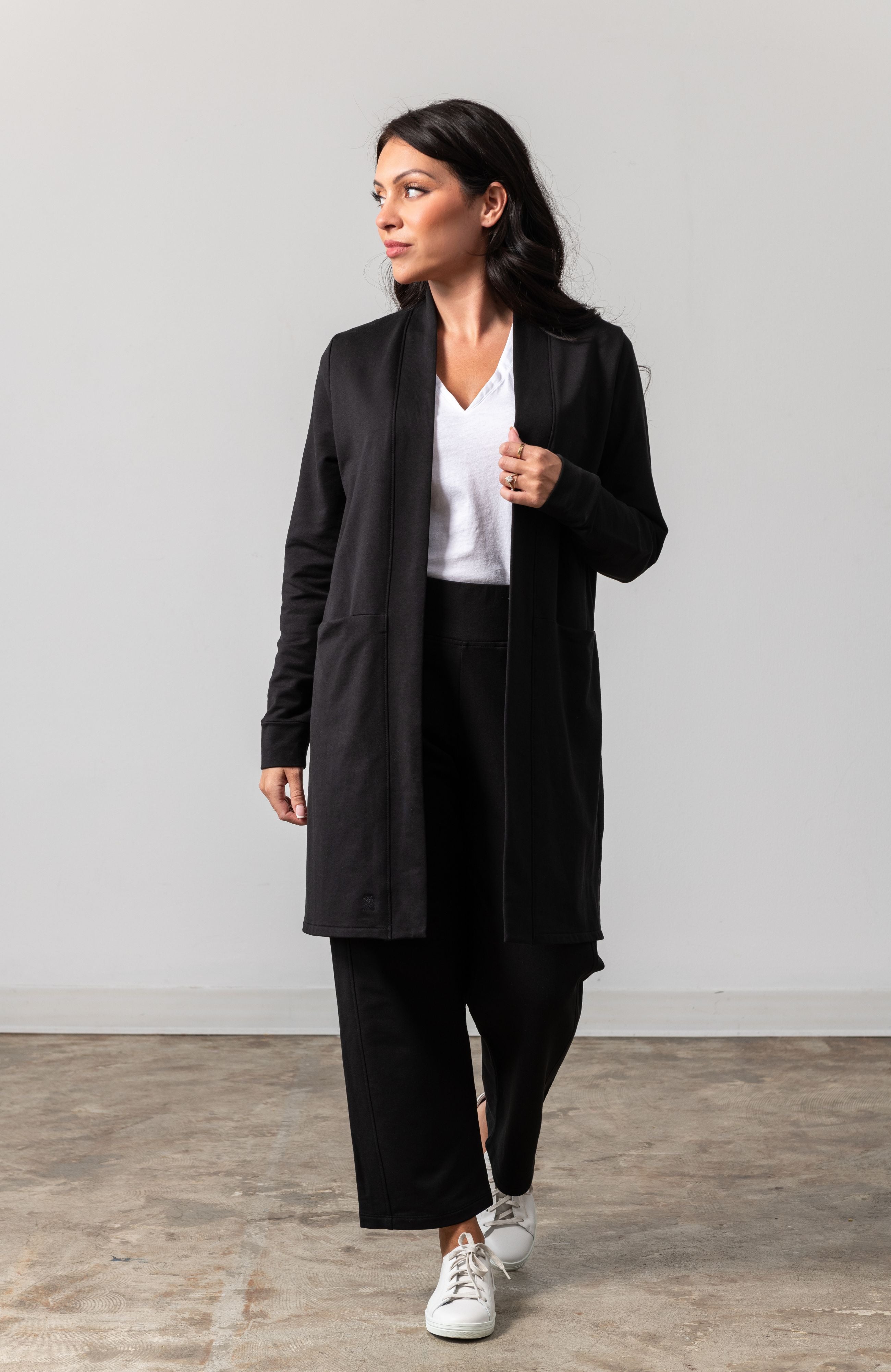 Woman shown wearing black cardigan