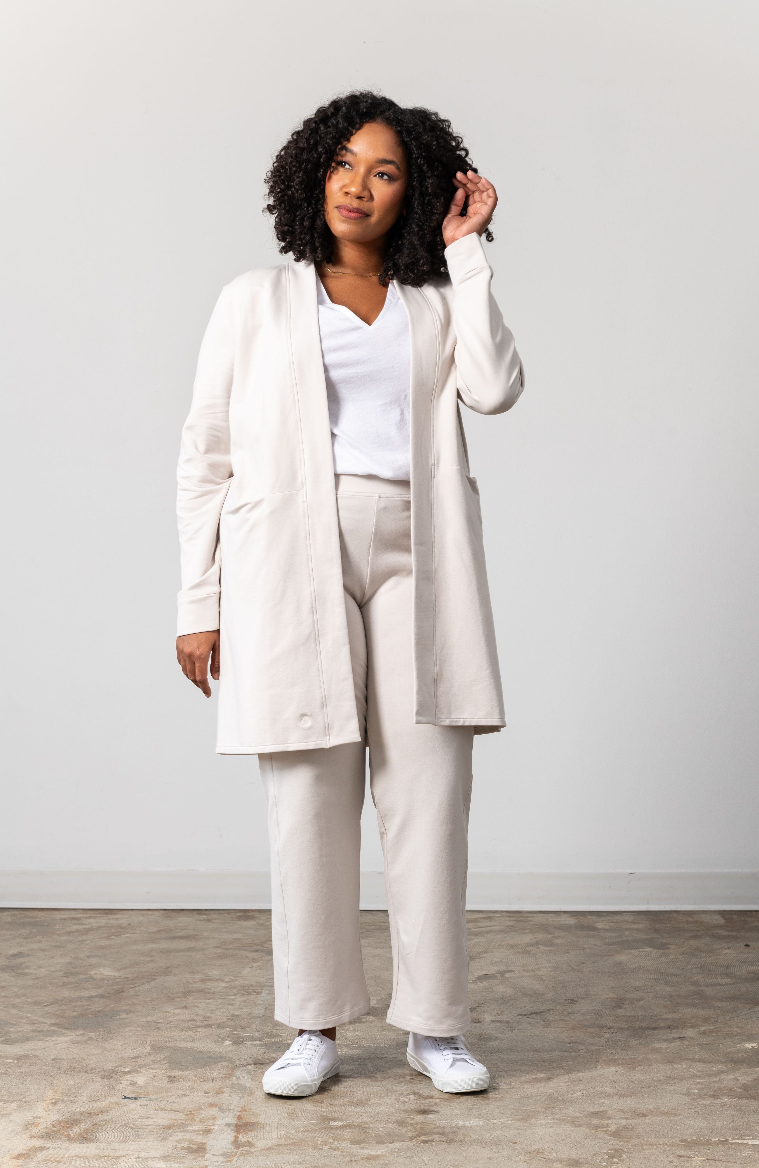 Woman shown wearing light beige cardigan