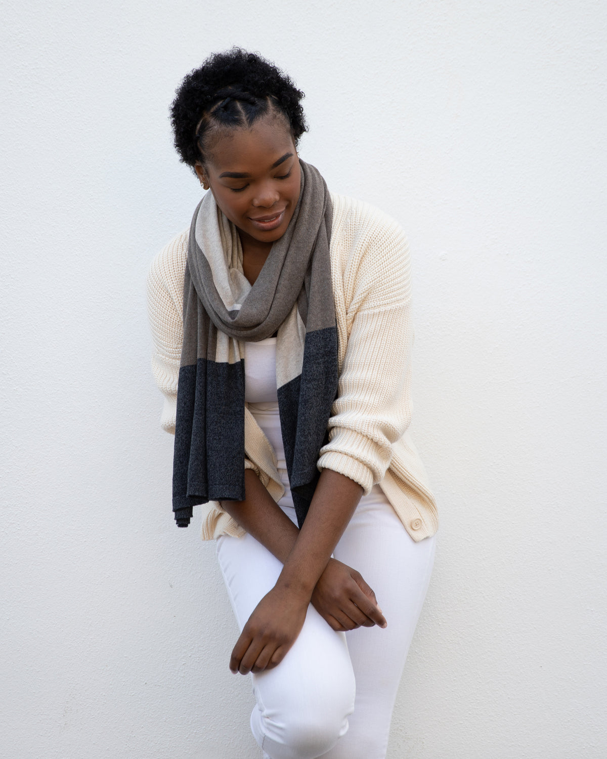 Woman wearing the Dreamsoft Travel Scarf in Brownstone Colorblock which is a brown, tan and gray scarf, worn as the modern loop around her neck