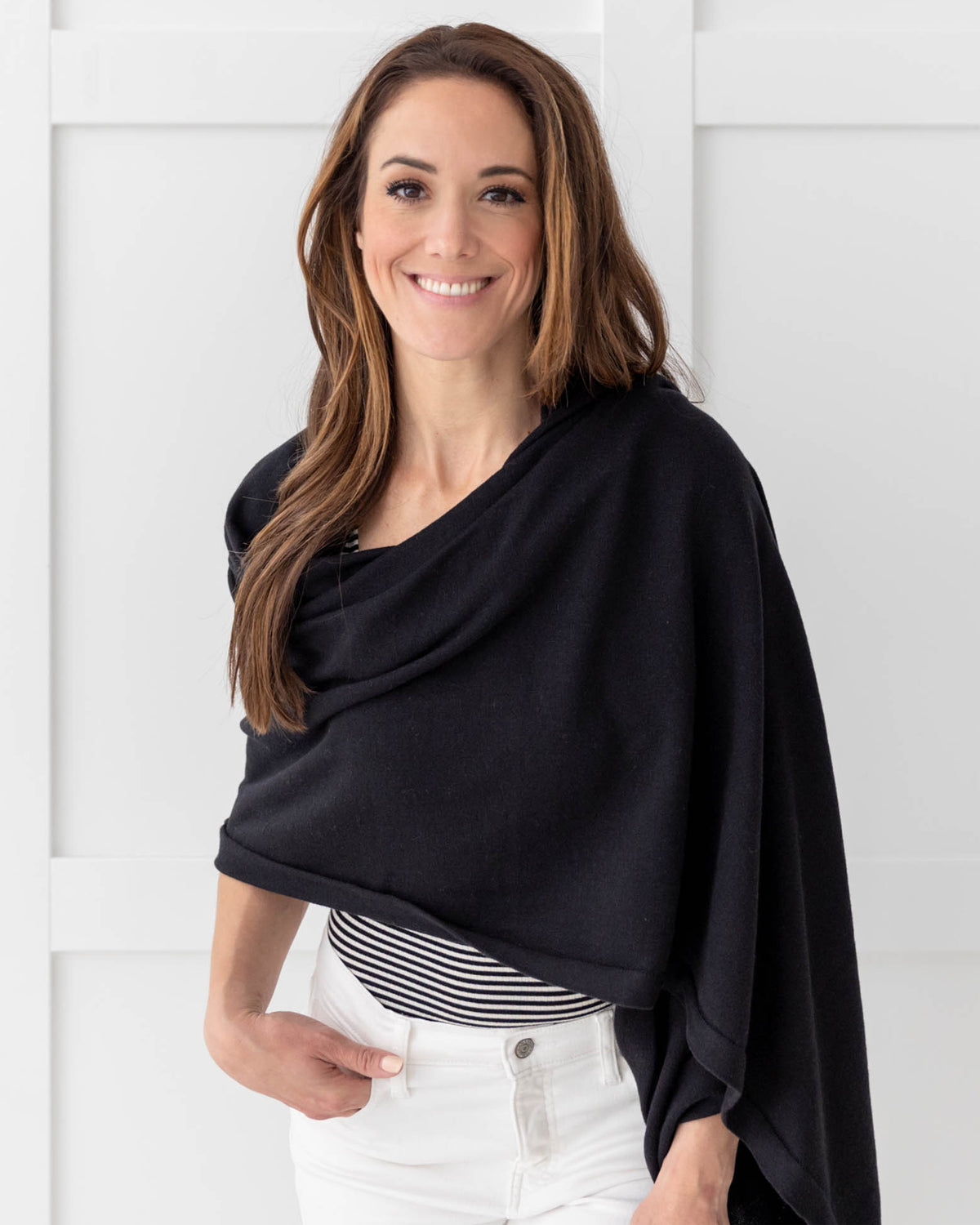 Woman wearing the Dreamsoft Travel Scarf in Black, with hand in her pocket